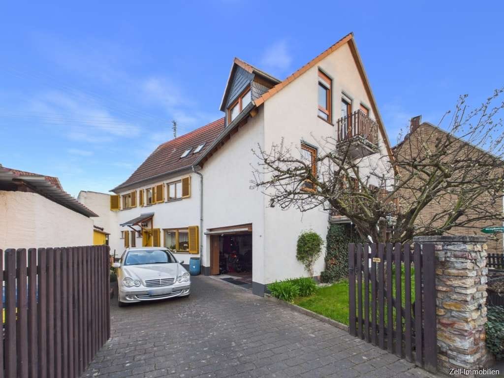 Immobilie in Oestrich-Winkel - Tolles Einfamilienhaus mit separater Wohnung im Anbau und Garage in zentraler Lage von Oestrich - Bild 0