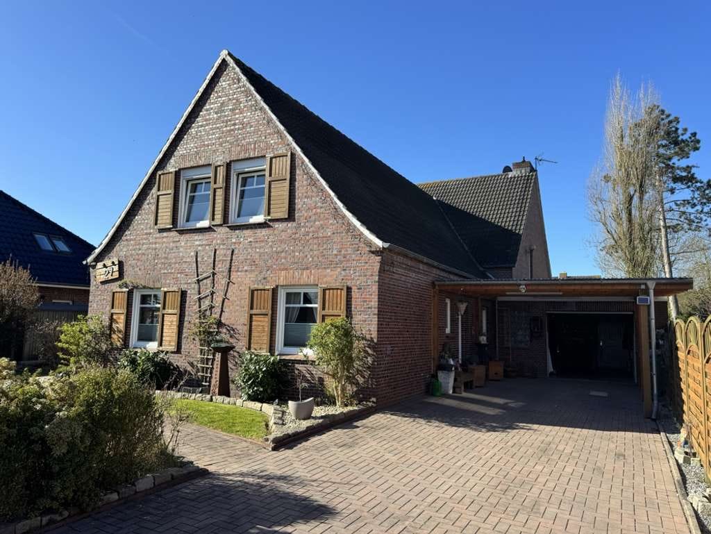 Immobilie in Südbrookmerland - Großzügiges Einfamilienhaus mit Wintergarten, schönem Garten und Garage in Sackgassenlage - Bild 1