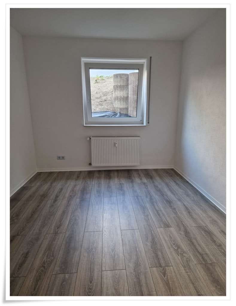 Immobilie in Eich - Erstbezug nach Kernsanierung 4 Zi.- Souterrain-Whg. -Ruhige Wohnlage- - Bild 3